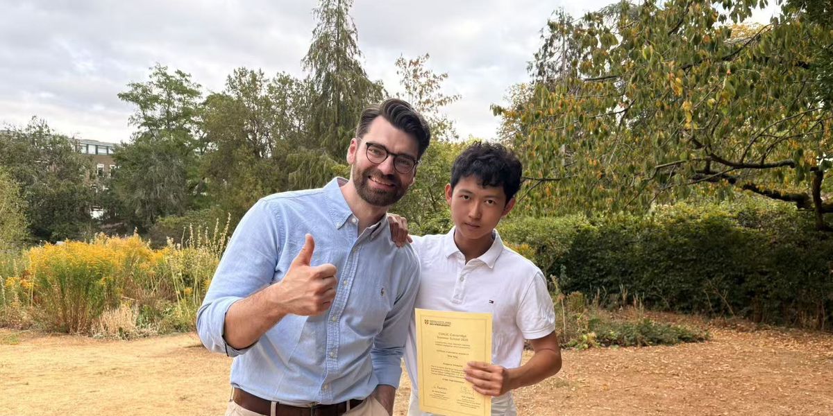 A teacher and a student with his certificate on the last day of the 2026 summer school