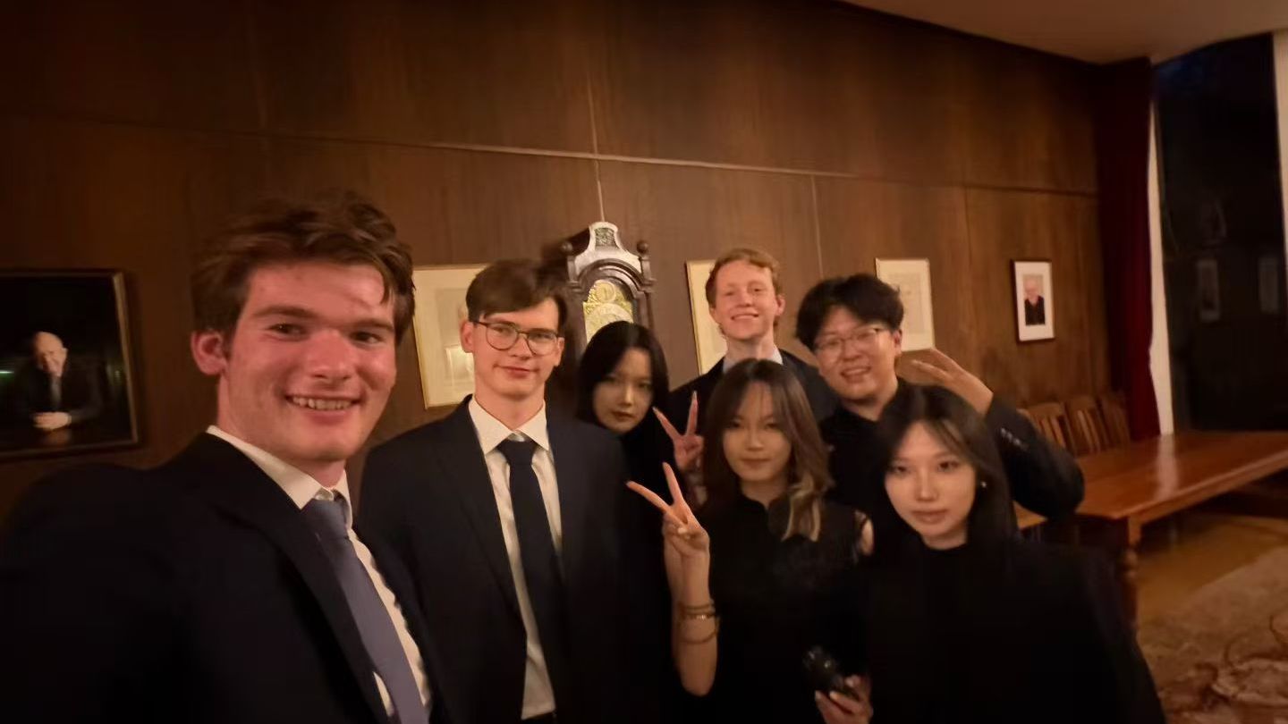 Summer school students in suits and dresses taking a selfie together after a formal dinner in 2026