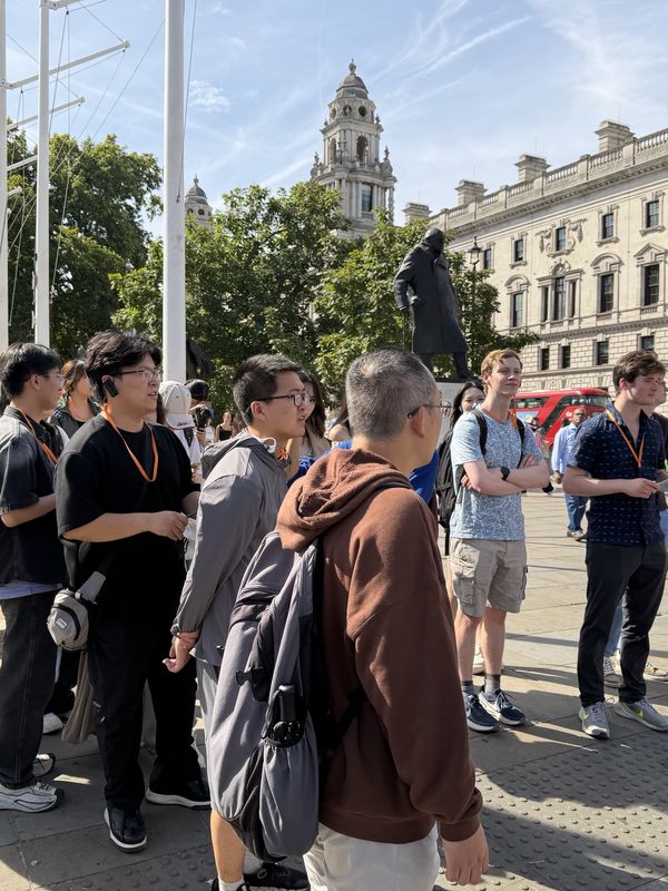 Students on the day trip to London, in Parliament Square, with Churchill’s statue and a red bus behind them