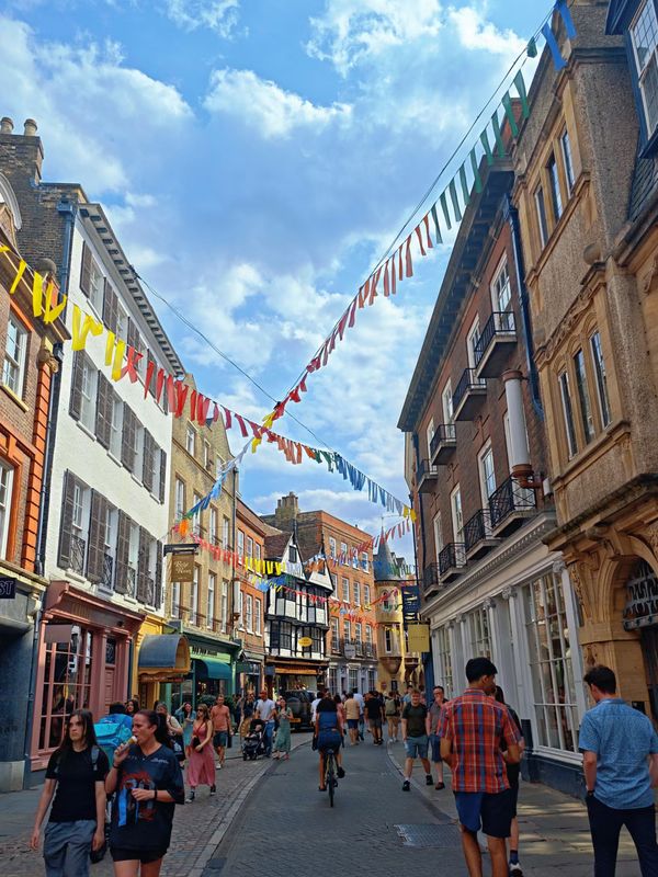 A busy street in the city centre under summer bunting