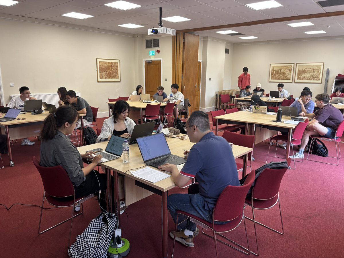 Teams at work on their laptops in a seminar room