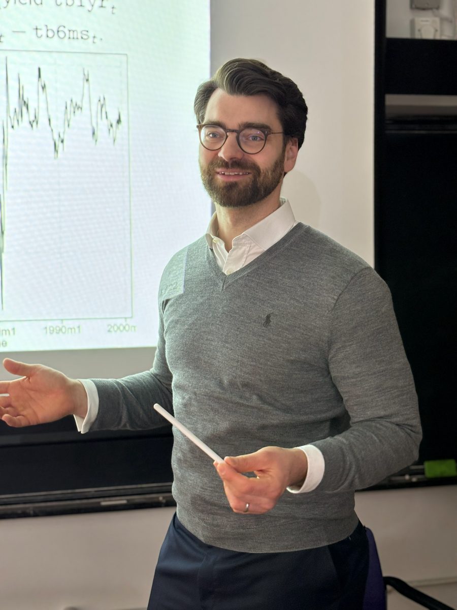 A Cambridge lecturer explains a chart to the class