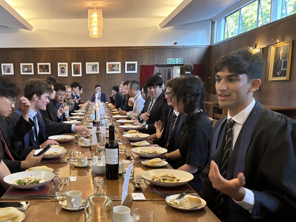 Students at a formal dinner in a college hall