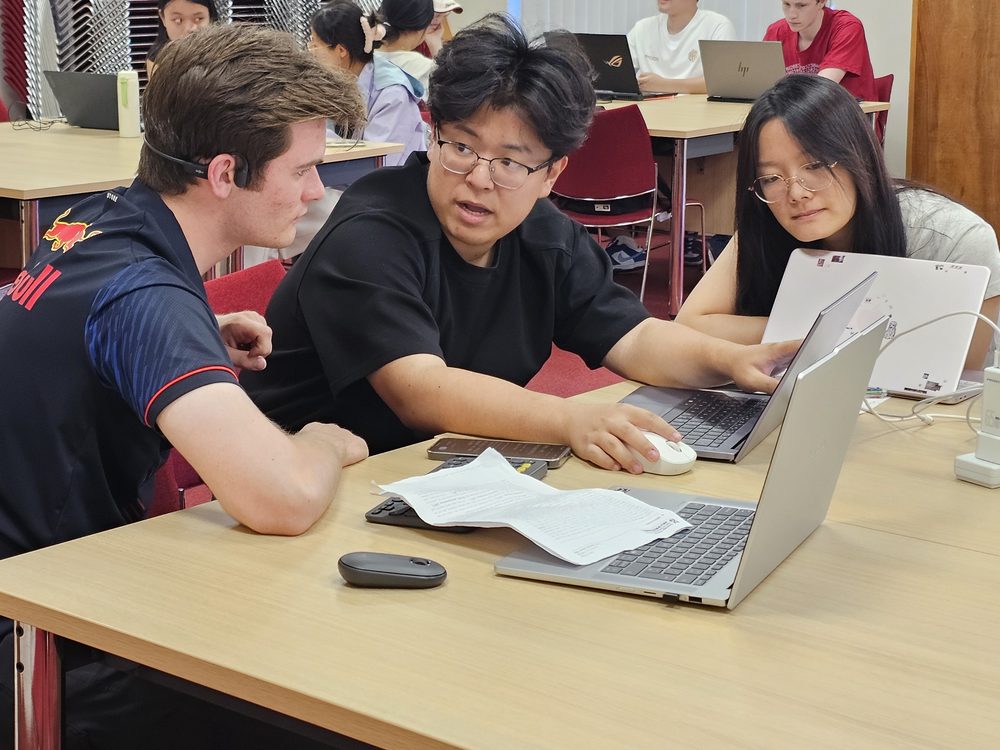 A team of three working together at a laptop