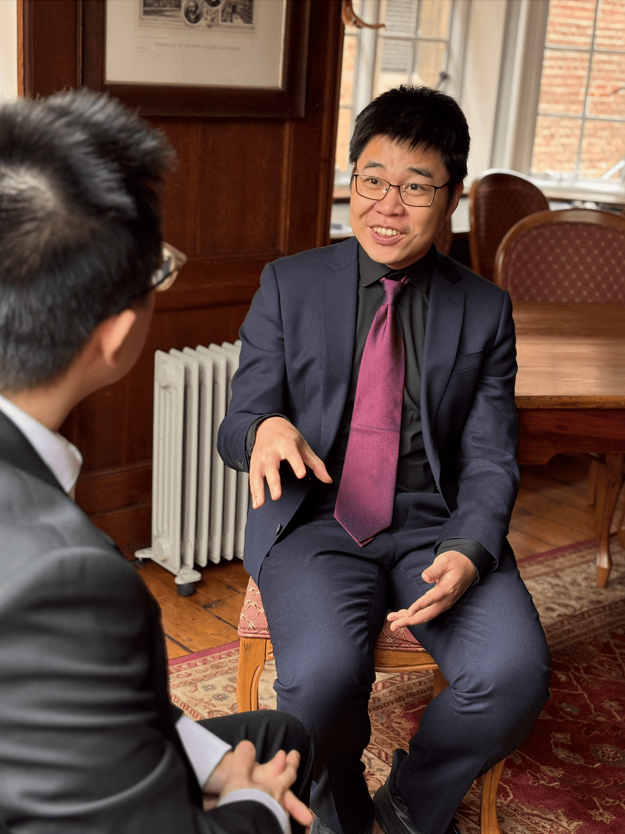 Weilong Zhang, one of our teachers, in conversation with a student